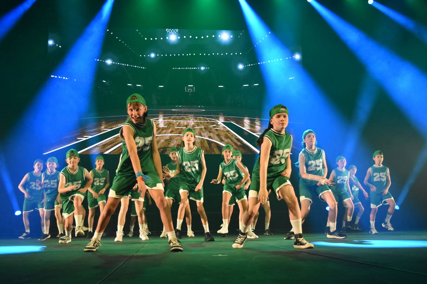 Photo of group of Woodend Primary School students performing in drama production its upgraded multipurpose gymnasium