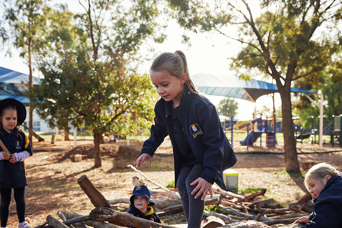 Photo of primary school students playing on nature playground