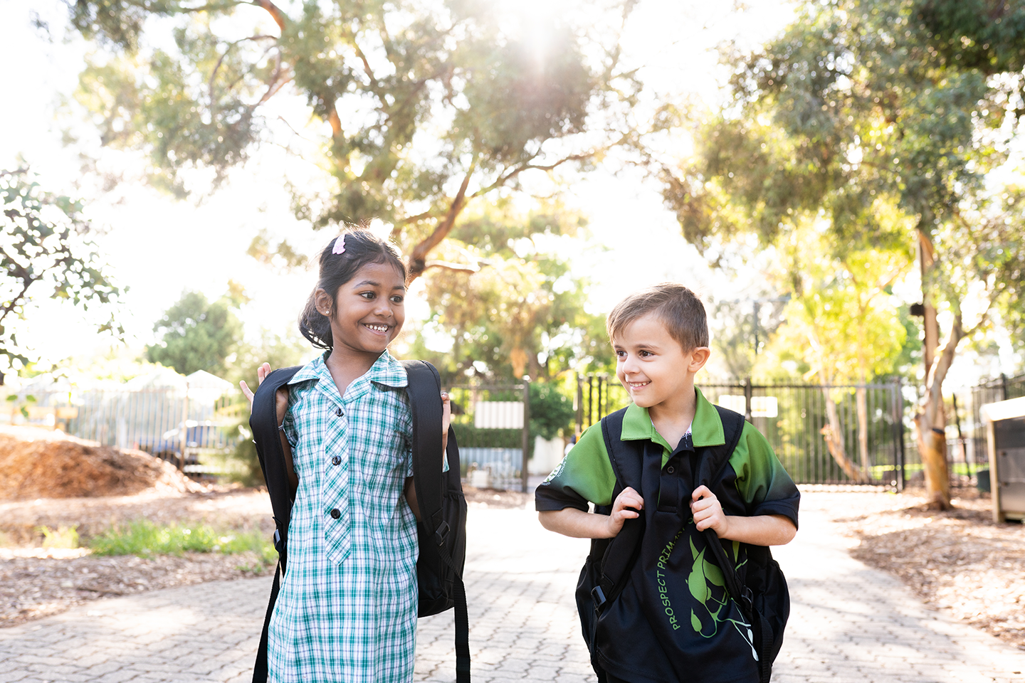 Photo of two primary school students walking to school