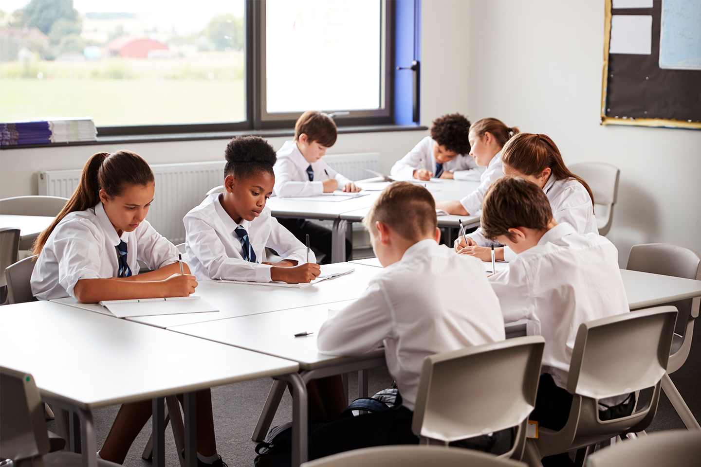 Photo of students completing test on laptops