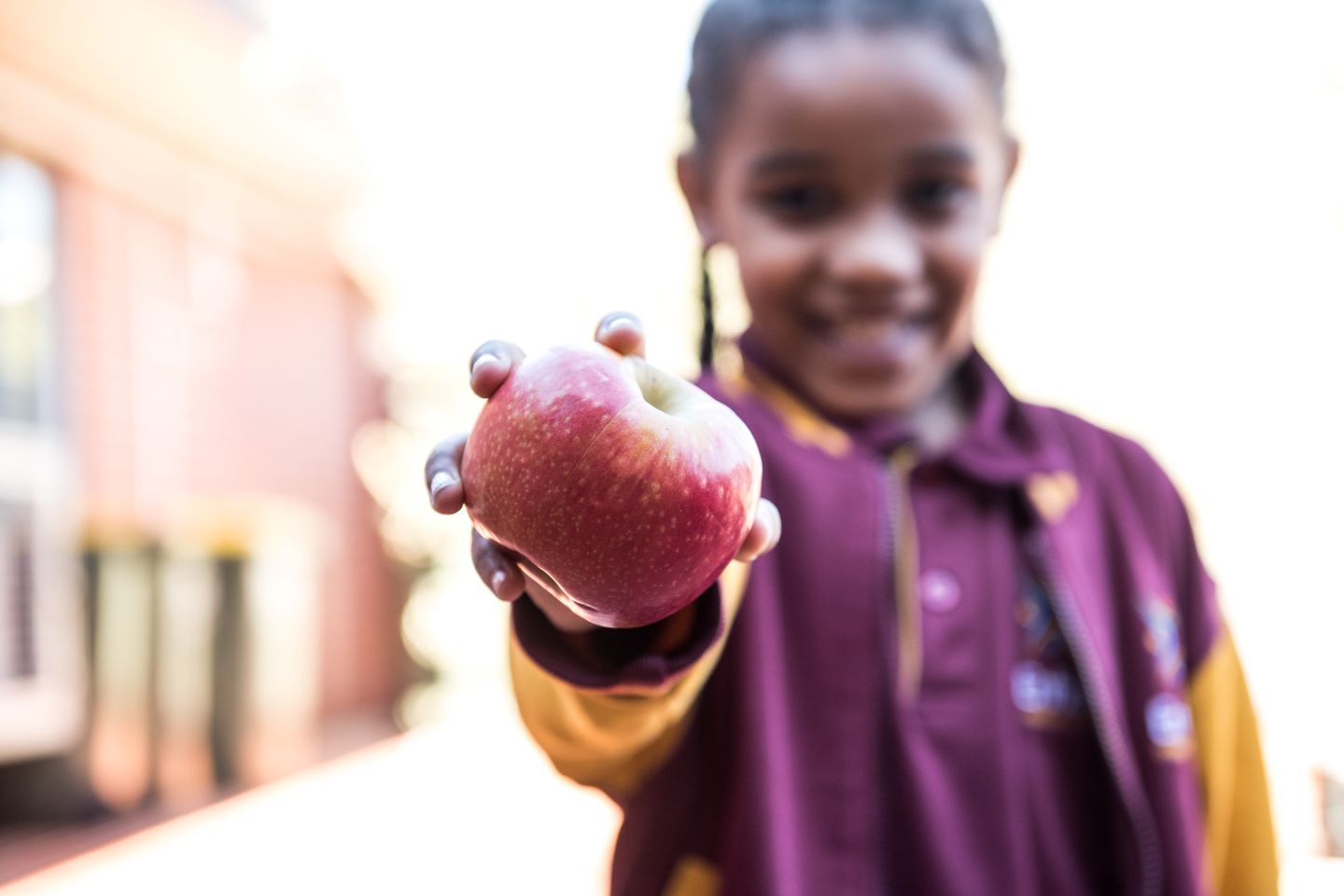 Student holding an apple 